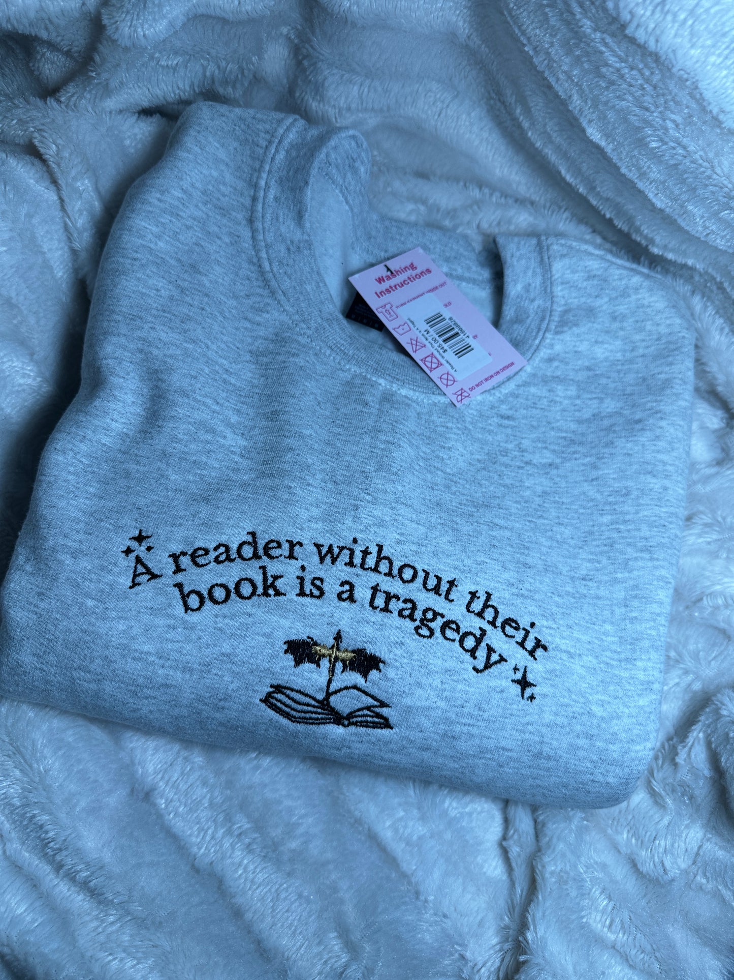 A Reader Without Their Book Is A Tragedy Crewneck